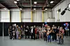 Newly arrived South Africans wait to hear welcome remarks from U.S. government officials in a hangar at Atlantic Aviation Dulles, near Washington Dulles International Airport, on May 12, 2025, in Dulles, Virginia.