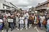 Protesters carry placards during a protest march against undocumented migrants in the town of Estcourt on April 24, 2026.