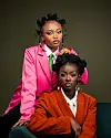 Gloria Munga (standing) and Maggie Atieno (sitting) of We Are Nubia pose in a studio.
