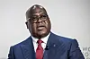 Democratic Republic of Congo President Felix Tshiseked is speaking, dressed in a striped navy suit, white shirt, and red tie.