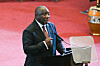 South African President Cyril Ramaphosa speaking at a podium, gesturing with his hand.