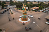 A view of Burkina Faso’s famous landmark, the filmmakers' roundabout, in Ouagadougou, with cars and motorbikes around it.
