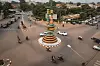 A view of Burkina Faso’s famous landmark, the filmmakers' roundabout, in Ouagadougou, with cars and motorbikes around it.
