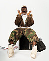 Nigerian producer Magicsticks poses holding his chain.
