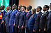 African heads of state and the French president stand in a line during the African Union anthem at a summit in Nairobi.