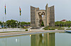 Independence monument in Lomé, Togo, beside a reflecting pool and flagpoles.
