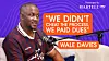 Wale Davies is seated at a microphone in front of a purple backdrop featuring a quote graphic.
