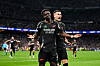Bukayo Saka of Arsenal celebrates scoring his team's first goal with teammate Gabriel Martinelli during the UEFA Champions League 2024/25 Quarter Final Second Leg match between Real Madrid C.F. and Arsenal FC at Estadio Santiago Bernabeu on April 16, 2025 in Madrid, Spain.