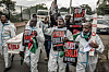 Activists chant slogans as they carry placards and a mock coffin during a protest against a US-built Ebola quarantine center planned to begin operations at Kenya's Laikipia Air Base, in Nairobi on June 2, 2026.
