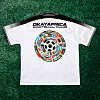 White Okaya Africa Football Club jersey with a multicolored soccer design on green grass.
