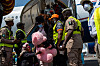 Passengers and officials stand on airport steps beside a chartered plane after repatriation arrival in Lagos.