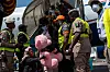 Passengers and officials stand on airport steps beside a chartered plane after repatriation arrival in Lagos.