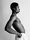 Black-and-white side profile of a shirtless Bongeziwe Mabandla standing against a plain backdrop.
