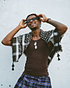 A shot of hip-hop artist Joey B in front of a white wall