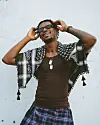 A shot of hip-hop artist Joey B in front of a white wall
