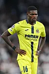 Thomas Partey is wearing Villarreal's yellow kit during a Champions League match.