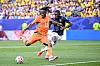 Cote d'Ivoire and Ecuador players battle for possession during a World Cup match on a grass field.