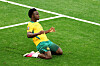 Australia player kneels and celebrates on the pitch after scoring at BC Place.