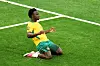 Australia player kneels and celebrates on the pitch after scoring at BC Place.