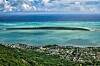 Aerial view of a tropical island lagoon near Mauritius with coastline and homes below.