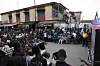 A large crowd of football fans watches an Afcon quarterfinal on an outdoor screen in Lagos.