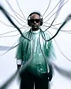 Man in sunglasses and headphones standing amid radiating dark cables on a white background.