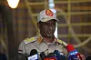 Mohamed Hamdan Dagalo speaks at a press conference in Khartoum with several microphones in front of him.