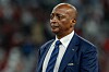 Patrice Motsepe in a blue suit at Khalifa International Stadium during a World Cup match in Doha.