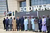 A group of officials stands for a photo outside the new ECOWAS headquarters building in Abuja.
