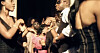 Crowd of people dancing closely at an outdoor party in warm evening light.