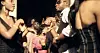 Crowd of people dancing closely at an outdoor party in warm evening light.