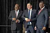South African President Cyril Ramaphosa (L) smiles as South African Minister of Agriculture John Steenhuisen (C) shakes hands with South African Deputy President Paul Mashatile (R) at the sitting of the South African Parliament for the swearing in of Cabinet Ministers, on July 03, 2024, in Cape Town.