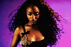 An image of Ayra Starr behind a purple background