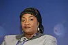 Jewel Cianeh Taylor sits before a blue backdrop at an economic forum in Poland.