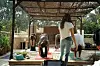 A yoga instructor is teaching a yoga class on the roof of Yellow Tape Records & Culture, for people are bending over on colorful yoga mats.