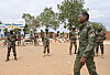 Nigerien soldiers stand in a dusty open area near a military base in Niamey.