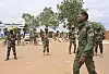 Nigerien soldiers stand in a dusty open area near a military base in Niamey.