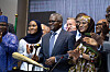 Aliko Dangote stands with guests at a Dangote Refinery IPO ceremony in Lagos as attendees applaud.