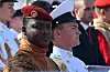 Ibrahim Traore in a red beret stands beside a Russian naval officer in white at a parade.