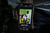 A man holds a mobile phone displaying the portrait of Geraldine Achiah, a victim of femicide, in Yaounde on September 10, 2026.