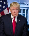President Donald Trump looking straight ahead, an American flag behind him.