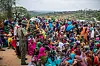 A large crowd of Ethiopian refugees gathers at Somare camp in Moyale, with a relief worker standing among them.