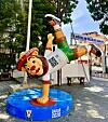 Colorful Ayo lion mascot statue on a Dakar 2026 pedestal outside Dakar City Hall.