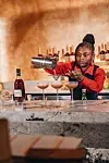 Lagos-based bartender Happiness Cletus mixes up a Hennessy drink.