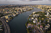 Aerial view of Lagos Island and Victoria Island separated by a wide waterway and surrounded by dense development.