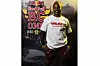 Acy Kare stands smiling in front of the Red Bull BC One World Final backdrop in Rio de Janeiro, wearing a Halisi Breakin shirt.