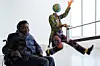 A photo of Yinka Shonibare MBE posing with his work \u201cEnd of Empire\u201d at Turner Contemporary as part of the 14-18 NOW programme.
