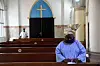 A Nigerian woman prays in a catholic church