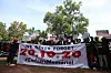 Protesters gather with placards in their hand, during a protest to commemorate one year anniversary of EndSars, a protest movement against police brutality at the Unity Fountain in Abuja, on October 20, 2021. - Hundreds of youth match to commemorate one year anniversary of Endars protest that rocked the major cities across the country on October 20, 2020.