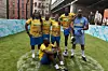 A group of former Mamelodi Sundowns players pose together on a rooftop football field